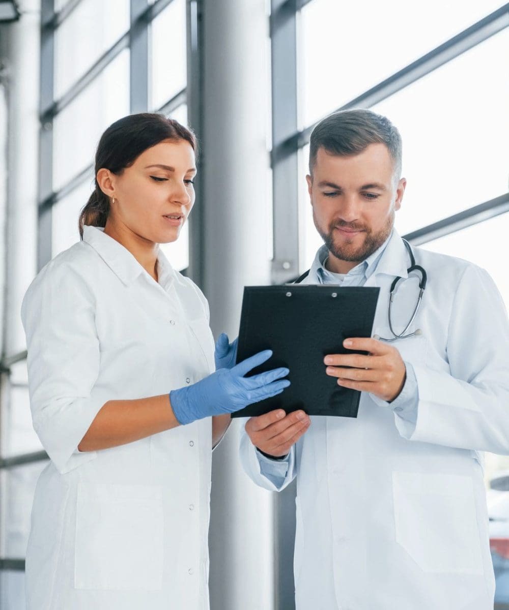 busy-people-two-doctors-in-white-coats-is-in-the-clinic-working-together